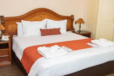 a hotel room with a bed with towels on it at Miraflores Colon Hotel in Lima