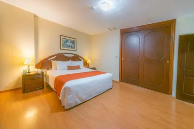 a hotel room with a bed and a door at Miraflores Colon Hotel in Lima