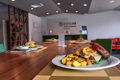 a table with plates of food on top of it at Estelar Apartamentos Bellavista in Lima