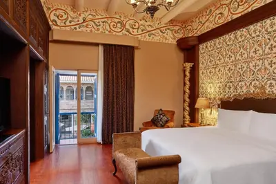 a bedroom with a bed and a large window at Palacio del Inka, a Luxury Collection Hotel, Cusco in Cusco