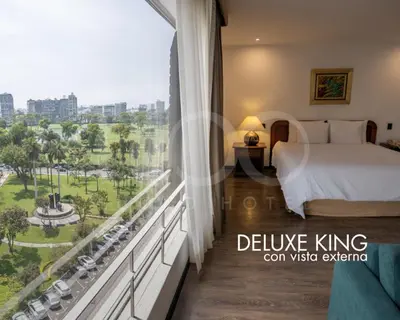 a hotel room with a bed and a large window at LUOXO Hotel in Lima