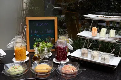 a buffet of food on a table with bowls of food at LUOXO Hotel in Lima