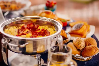 a pot of food sitting on a table with bread at Daniel's Apart Hotel in Lima