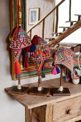 three umbrellas on a wooden table in front of a mirror at Luxury House & Unique Experience at Sacred Valley, Urubamba, Cusco in Urubamba