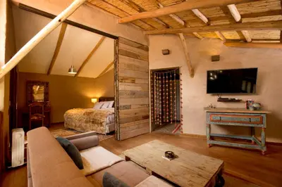 a living room with a couch and a bed at Luxury House & Unique Experience at Sacred Valley, Urubamba, Cusco in Urubamba