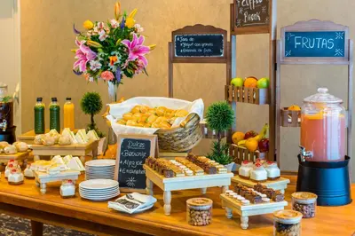 a table with a buffet of fruits and pastries at Delfines Hotel & Convention Center in Lima