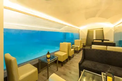 a waiting room with couches and a large aquarium at Delfines Hotel & Convention Center in Lima