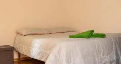 a green towel sitting on top of a bed at House in Cusco in Cusco