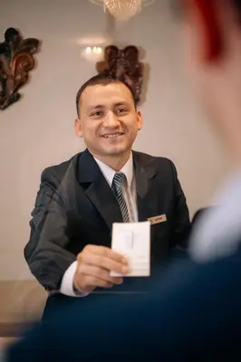 a man in a suit and tie holding a card at Hotel Carrera in Lima