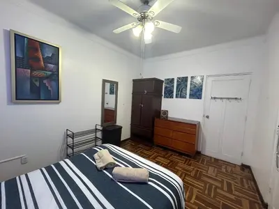 a bedroom with a bed and a ceiling fan at Departamento en San Isidro in Lima