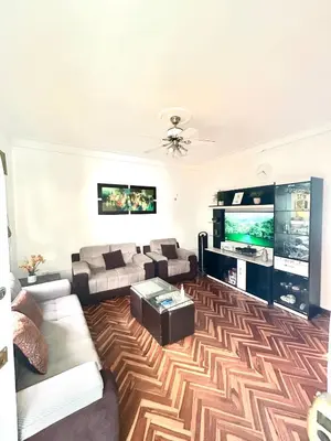 a living room with a couch and a flat screen tv at Departamento en San Isidro in Lima