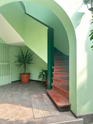 a staircase in a building with a green wall at Departamento en San Isidro in Lima