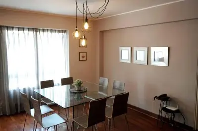 a dining room with a glass table and chairs at MLA apartments - Bolognesi in Lima