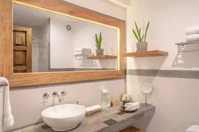 a bathroom with a sink and a mirror at Antigua Casona San Blas in Cusco