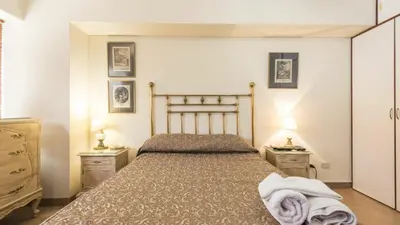 a bedroom with a bed with two night stands and two lamps at Apartamento Edificio Pardo Cinco in Lima