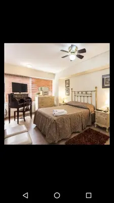 a bedroom with a piano and a bed with a bedskirtspectspectspectspects at Apartamento Edificio Pardo Cinco in Lima