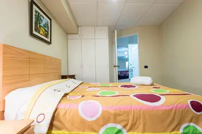 a large bed with a colorful blanket on it at Apartamento Edificio Pardo Cinco in Lima