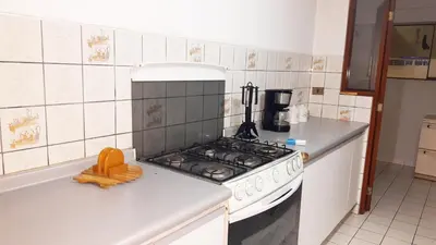 a kitchen with a stove and a white counter top at Apartamento Edificio Pardo Cinco in Lima