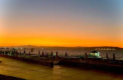 a pier with a sunset in the background at ooo OCEAN VIEW APARTMENT PARACAS SOTAVENTO ooo in Paracas