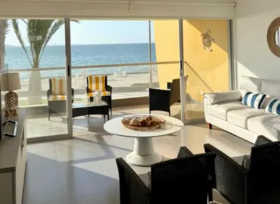 a living room with a couch and a table at ooo OCEAN VIEW APARTMENT PARACAS SOTAVENTO ooo in Paracas