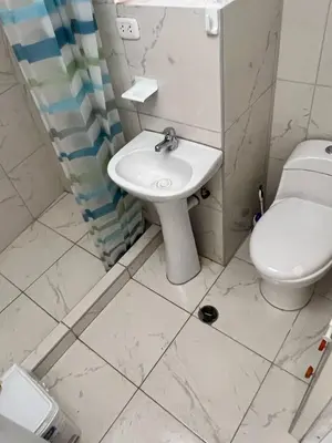 a bathroom with a toilet and a sink at Hospedaje Killipata in Cusco