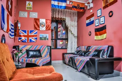 a room with two couches and flags on the wall at Hostal Berlin in Jauja