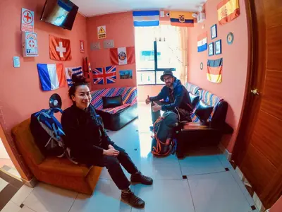 a couple of people sitting in a room at Hostal Berlin in Jauja