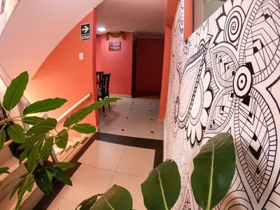 a hallway with a wall with a painting on it at Hostal Berlin in Jauja
