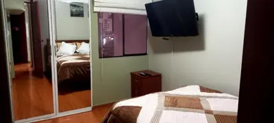 a bedroom with a mirror and a bed and a tv at Departamento Jesus Maria in Lima