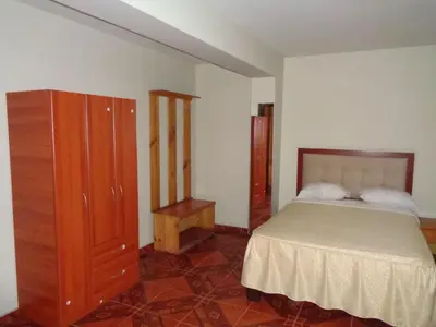 a bedroom with a bed and a dresser at Antares Inn in Lima