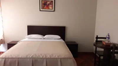 a bedroom with a bed with two pillows on it at Antares Inn in Lima