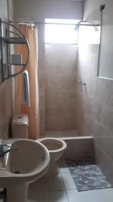 a bathroom with a sink and a toilet and a shower at Antares Inn in Lima