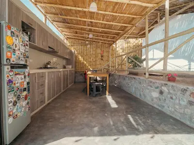 a kitchen with a refrigerator and a table in it at Ecocamp Huacachina in Ica