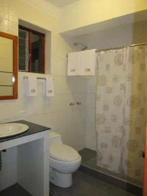 a bathroom with a toilet and a sink at Cusco House in Cusco