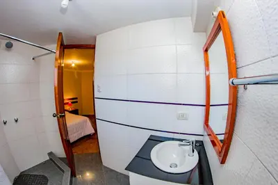 a bathroom with a toilet and a sink at Cusco House in Cusco