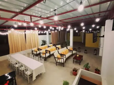 a room with couches and tables and chairs in it at Victtorios Hotel in Satipo