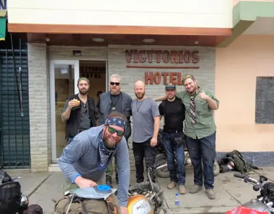 a group of men standing in front of a hotel at Victtorios Hotel in Satipo
