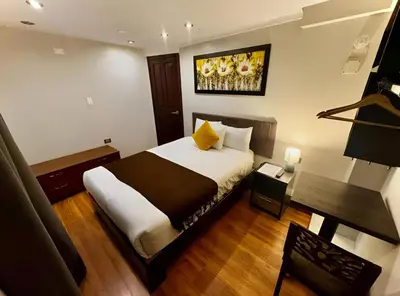 a hotel room with a bed and a desk at Tikala Cusco Boutique Hotel in Cusco