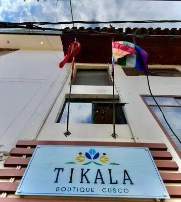 a sign on the side of a building at Tikala Cusco Boutique Hotel in Cusco