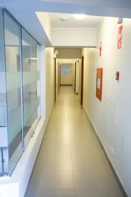 a hallway in a hospital with a long corridor at Mariategui Hotel & Suites in Lima