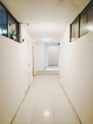 an empty hallway with white walls and windows at Departamento Monterrico in Lima
