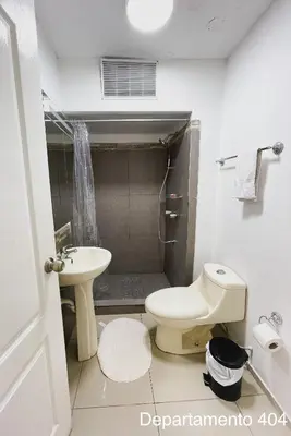 a bathroom with a toilet and a sink at Departamento Monterrico in Lima