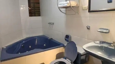 a bathroom with a tub and a toilet and a sink at CasaHotel Jockey Plaza Mall in Lima