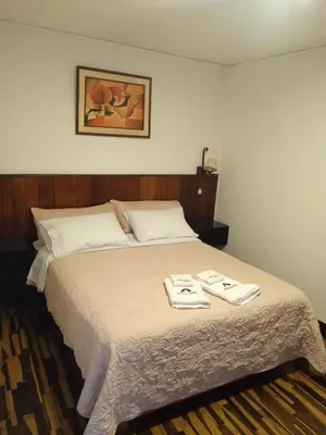 a bedroom with a bed with two towels on it at CasaHotel Jockey Plaza Mall in Lima