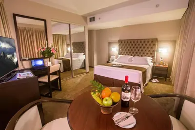 a hotel room with a table with fruits and wine bottles at Del Pilar Miraflores Hotel in Lima