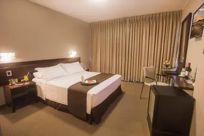 a hotel room with a bed and a desk and chair at Del Pilar Miraflores Hotel in Lima