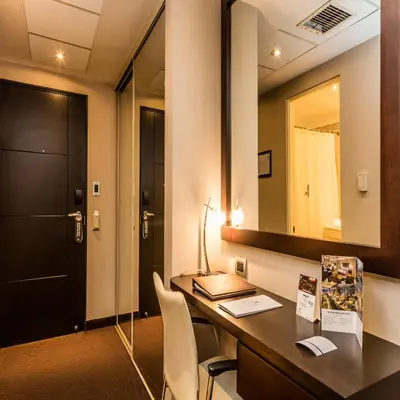 a room with a desk and a mirror at Del Pilar Miraflores Hotel in Lima
