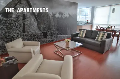 a living room with a couch and chairs and a wall at Mariel Hotel Boutique in Lima