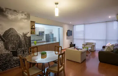 a living room with a table and a couch at Mariel Hotel Boutique in Lima