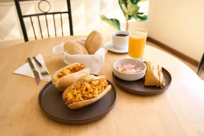 a table with two plates of food on a table at Hotel Park Suites in Lima